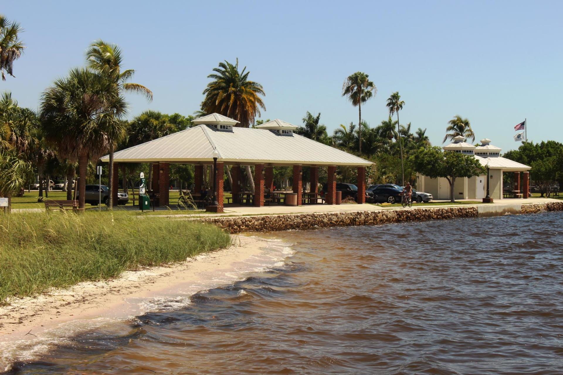 gilchrist pavilion with person biking on path along the water 